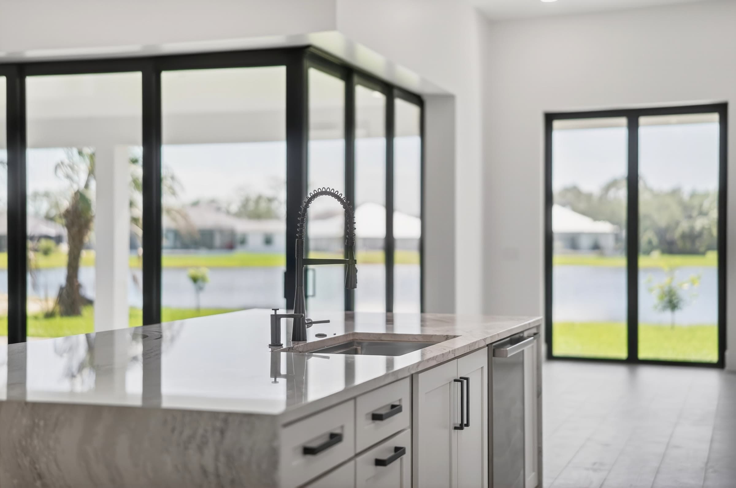A cinematic kitchen listing photo with a lake view — representative of PMH's full media package