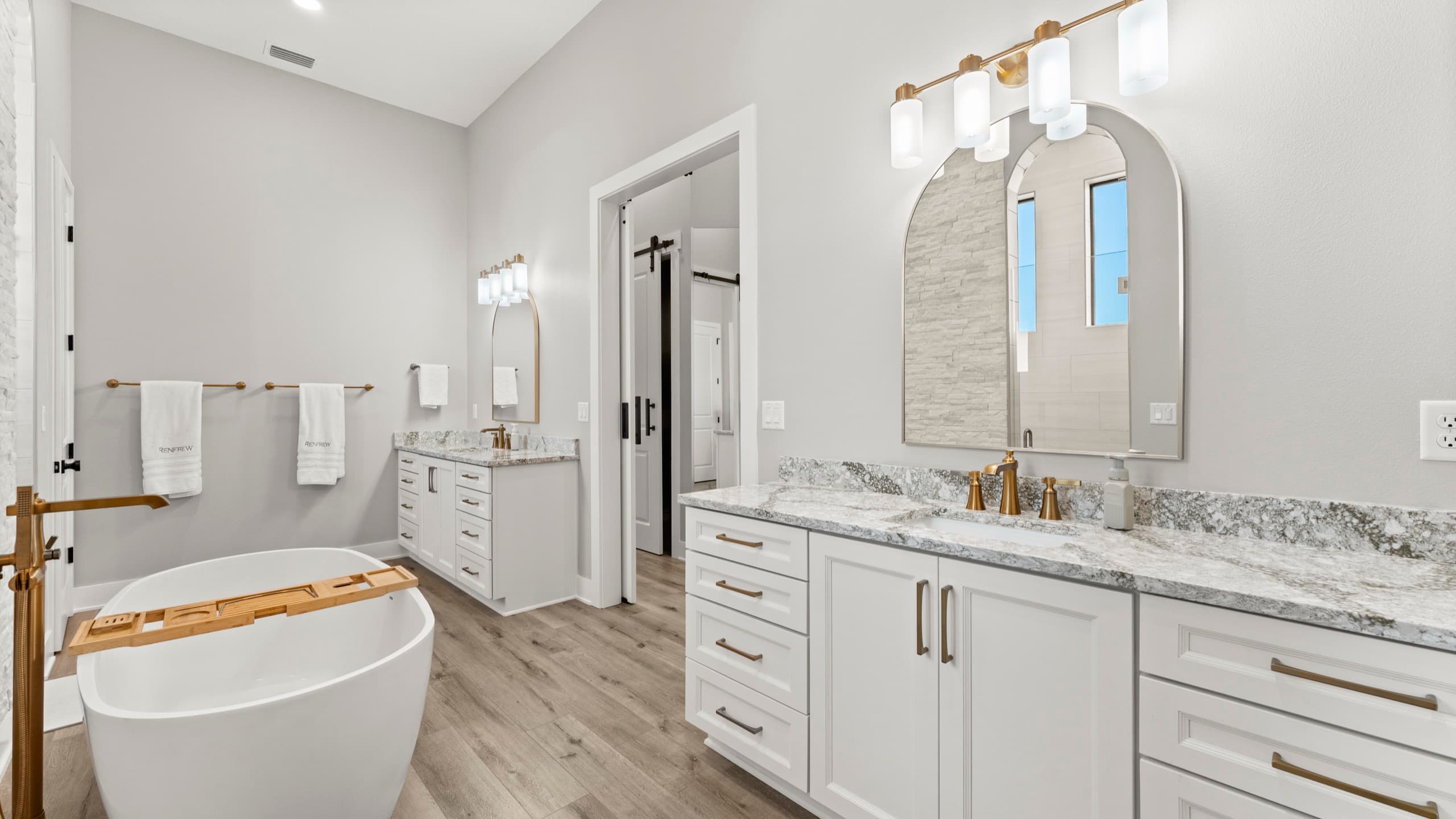 Master bathroom with freestanding tub and natural light