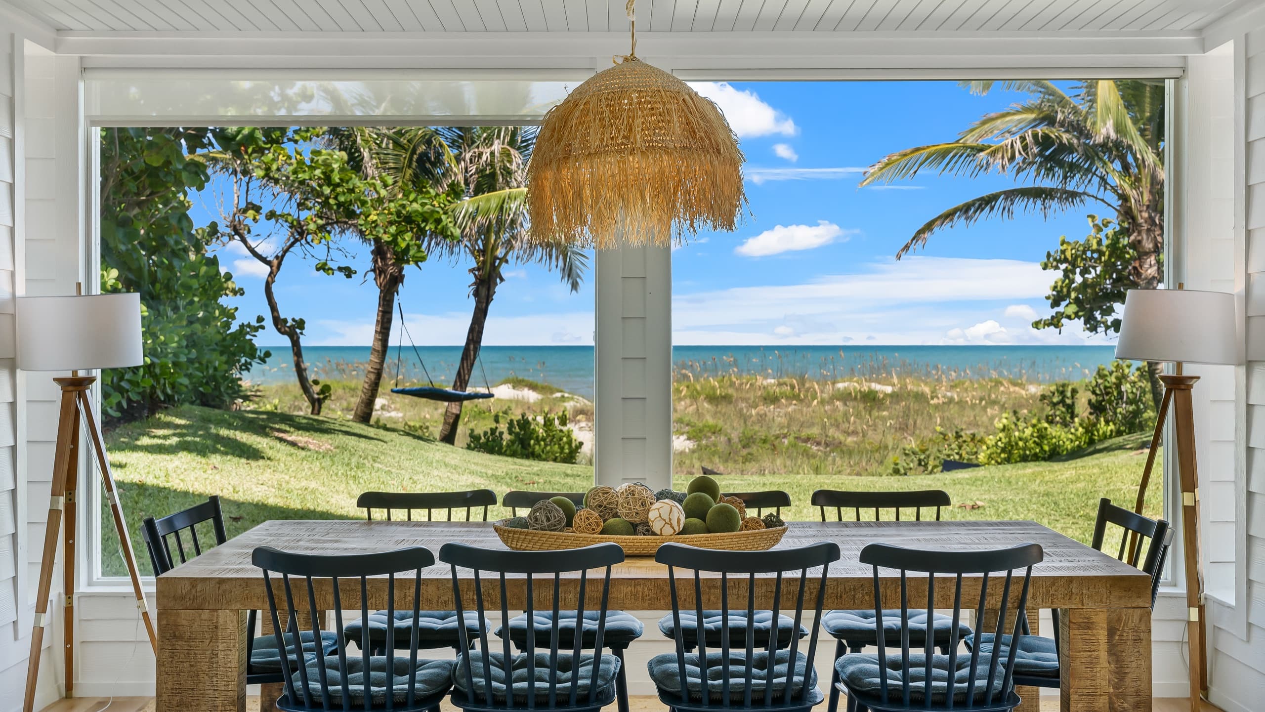 Oceanfront lifestyle frame showing the coastline beyond the home